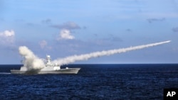 FILE - In this Friday, July 8, 2016, file photo released by Xinhua News Agency, Chinese missile frigate Yuncheng launches an anti-ship missile during a military exercise in the waters near south China's Hainan Island and Paracel Islands.