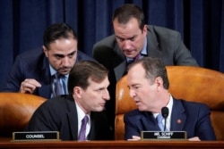 House Intelligence Committee Chairman Adam Schiff (D-CA) speaks with Democratic Counsel Daniel Goldman (L) and other staffers during testimony from Marie Yovanovitch, former U.S. ambassador to Ukraine, during a House Intelligence Committee hearing.