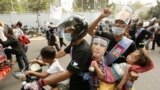 A family takes part in a rally to mark the World Women&#39;s Day, in Phnom Penh, Cambodia, March 8, 2013.&nbsp;