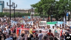 People hold posters reading "Freedom for Khabarovsk region's governor Sergei Furgal, I'm, we are Sergei Furgal, Call Furgal home" during a protest in Khabarovsk, 6100 kilometers (3800 miles) east of Moscow, Russia, July 18, 2020.