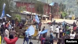 FILE - Protesters wave Ambazonian flags at a roadblock in the English-speaking city of Bamenda, Cameroon, Oct. 1, 2017. Ambazonia is a self-declared state consisting of the Anglophone portions of Cameroon.