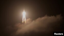 FILE - The Long March-5 Y5 rocket, carrying the Chang'e-5 lunar probe, takes off from Wenchang Space Launch Center, in Wenchang, Hainan province, China, Nov. 24, 2020. 