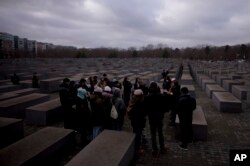 Tourists visit the Holocaust Memorial in Berlin, Germany, on International Holocaust Remembrance Day, Jan. 27, 2024, marking the anniversary of the liberation of the Nazi death camp Auschwitz-Birkenau in 1945.