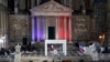 The coffin of slain teacher Samuel Paty is carried away in the courtyard of the Sorbonne university during a national memorial event, Oct. 21, 2020 in Paris.