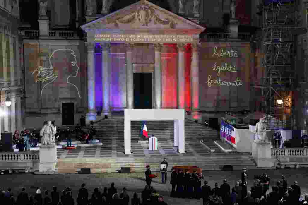 The coffin of slain teacher Samuel Paty is carried away in the courtyard of the Sorbonne university during a national memorial event, Oct. 21, 2020 in Paris, France.