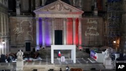 The coffin of slain teacher Samuel Paty is carried away in the courtyard of the Sorbonne university during a national memorial event, Oct. 21, 2020 in Paris.