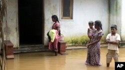 FILE - Monsoon rains hit Sri Lanka, hurting families and farmers.