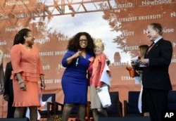 Newhouse School Dean Lorraine Branham, left, joins Oprah Winfrey (center) at 2014 event at the school. (Heather Ainsworth/AP Images for Syracuse University)