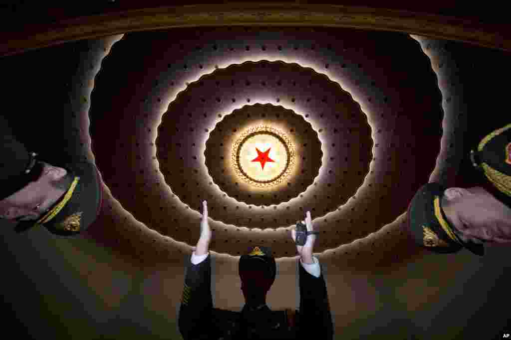 A military band conductor rehearses ahead of the closing session of the annual National People's Congress, held in the Great Hall of the People in Beijing, China.