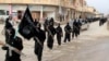 FILE - Fighters from the al-Qaida linked Islamic State of Iraq and the Levant (ISIL) marching in Raqqa, Syria.