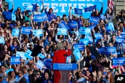 FILE - In this Nov. 7, 2016, file photo, Democratic presidential candidate Hillary Clinton waves to students standing behind her before speaking at a rally in front of the Cathedral of Learning on the University of Pittsburgh campus. (AP Photo)