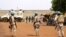 Des soldats sénégalais de la mission de maintien de la paix des Nations unies au Mali (MINUSMA) patrouillent à pied dans les rues de Gao, le 24 juillet 2019, au lendemain d'une attaque contre une base internationale de maintien de la paix au Mali.