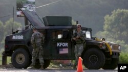 U.S. soldiers serving in the NATO-led peacekeeping force KFOR guard a checkpoint on a road near the village of Leposavic, northern Kosovo, Aug. 18, 2022. (AP Photo/Bojan Slavkovic, File)