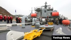 26일 한국 해군들이 신형 구조함인 통영함에서 예인기를 시연해보이고 있다. 