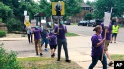 Workers demonstrate outside Cerenity Humboldt Care Center in St. Paul, Minn., July 20, 2020, to protest low wages and diminished sick pay amid the coronavirus pandemic.