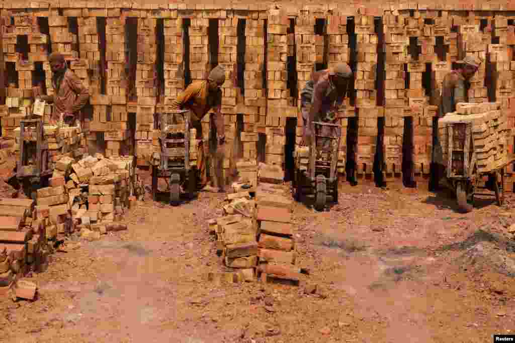 Laborers work at a brick kiln factory on the outskirts of Peshawar, Pakistan.