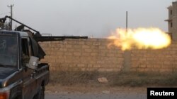 Members of the Libyan internationally recognized government forces fire during fighting with Eastern forces in Ain Zara, Tripoli, Libya, April 20, 2019.