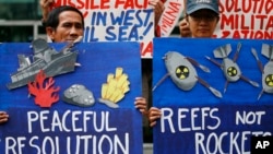 Environmental activists picket the Chinese Consulate to protest alleged military buildup by China on the disputed group of islands at the South China Sea, in Manila, Philippines, Jan. 24, 2017. The protesters condemned China's alleged installation of missile system across the disputed Spratlys group of islands.