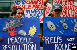 Environmental activists picket the Chinese Consulate to protest alleged military buildup by China on the disputed group of islands at the South China Sea, in Manila, Philippines, Jan. 24, 2017. The protesters condemned China's alleged installation of mis