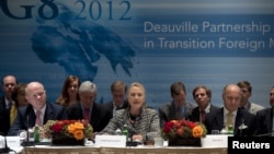 British Foreign Minister William Hague (L) and French Foreign Minister Laurent Fabius (R) listen as U.S. Secretary of State Hillary Clinton speaks during the G8 Deauville Partnership with Arab Countries in Transition meeting in New York, September 28, 201
