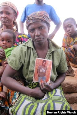 A Christian woman, from the Berom ethnic group, holds up a photograph of her son who was killed in a February 22, 2011 attack on Bere Riti village, Plateau State. (Photo:© 2012 Eric Guttschuss/Human Rights Watch)