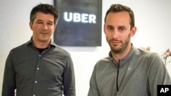 FILE - Then-Uber CEO Travis Kalanick, left, and Anthony Levandowski, co-founder of Otto, pose in the lobby of Uber headquarters, in San Francisco, Aug. 18, 2016. Uber said, in a June 22, 2017, court filing, that it hired Levandowski, a former Google engineer now accused of stealing trade secrets, even though the company knew he had information that didn't belong to him. 