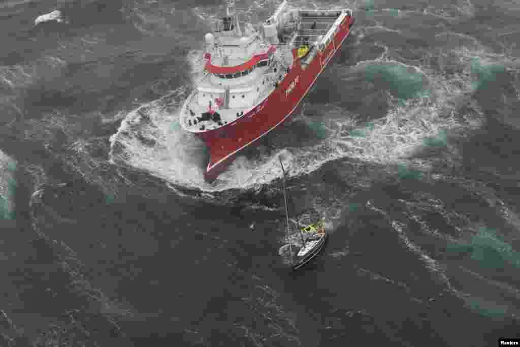 Research vessel Thor Magni rescues two people aboard a racing yacht in high seas in the mid-Atlantic, 250 nautical miles east of St. John&#39;s, Newfoundland , Canada, June 10, 2017. (Courtesy: JTFA/Canada Armed Forces)
