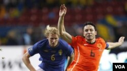 Pemain Swedia Ola Toivonen menyelengkat kapten timnas Belanda Mark van Bommel (kanan) dalam sebuah pertandingan kualifikasi Piala Eropa 2012.