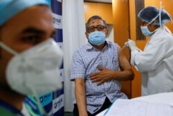 An elderly man receives a dose of COVISHIELD, the coronavirus vaccine manufactured by Serum Institute of India, at Max Super Speciality Hospital, in New Delhi, India, March 17, 2021.