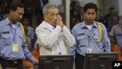 FILE - Former Khmer Rouge S-21 prison chief Duch (C) greets the court during his appeal hearing at the Court Room of the Extraordinary Chambers in the Courts of Cambodia (ECCC) on the outskirts of Phnom Penh, Feb. 3, 2012. 