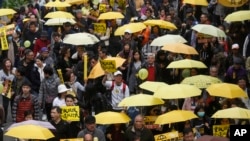 Thousands of pro-democracy activists take part in a democracy march to Central, demanding for universal suffrage in Hong Kong Sunday, Feb. 1, 2015. (AP Photo/Kin Cheung)