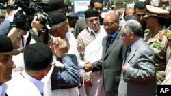 South African President Jacob Zuma (C-R) is greeted by Libyan PM Baghdadi al-Mahmudi (front-R) and local tribesmen upon his arrival in Tripoli on May 30, 2011