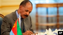FILE - Eritrean President Isaias Afwerki signs a peace accord with Ethiopia in Jiddah, Saudi Arabia on Sunday, Sept. 16, 2018. 