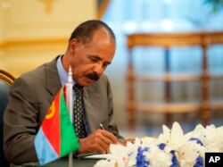 FILE - Eritrean President Isaias Afwerki signs a peace accord with Ethiopia in Jiddah, Saudi Arabia, Sept. 16, 2018.