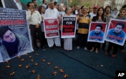 FILE - Members of a Pakistani civil society take part a demonstration against the killing of Mohammad Mashal Khan, a student at the Abdul Wali Khan University in the northwestern city of Mardan, in Karachi, Pakistan, April 22, 2017. A mob in the northwestern city of Mardan lynched the university student over alleged blasphemy.