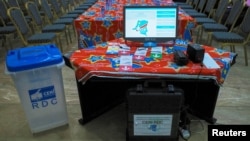 FILE - An electronic voting machine and a ballot box are seen inside the Congo's electoral commission (CENI) head offices at the Gombe Municipality in Kinshasa, Democratic Republic of the Congo, March 1, 2018.