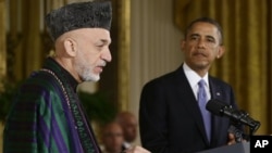 President Barack Obama listens as Afghan President Hamid Karzai speaks during a news conference in the East Room at the White House in Washington, January 11, 2013.