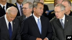 FILE - From left: Vice President Joe Biden, Senate Minority Leader Mitch McConnell, House Speaker John Boehner, Senate Majority Leader Harry Reid, Capitol Rotunda, Washington, Dec. 20, 2012.
