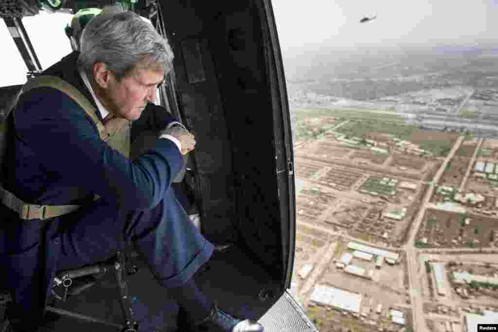 U.S. Secretary of State John Kerry, who arrived in Baghdad on Wednesday as he began a tour of the Middle East to build a coalition against the Islamic State militants, looks out over Baghdad from a helicopter, Sept. 10, 2014. 