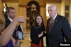 FILE - U.S. House Minority Whip Steny Hoyer, D-Md., right, talks to reporters.