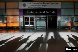 FILE - An international traveler arrives after U.S. President Donald Trump's executive order travel ban at Logan Airport in Boston, Massachusetts, Jan. 30, 2017.