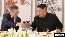 FILE - South Korean President Moon Jae-in makes a toast with North Korean leader Kim Jong Un during a luncheon at Samjiyon Guesthouse in Ryanggang province, North Korea, Sept. 20, 2018.
