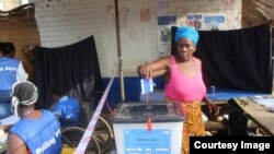 FILE - A woman votes in Liberia's Special Senatorial election.