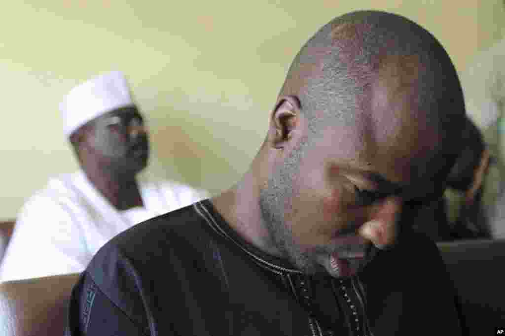 A suspected member of Islamic sect Boko Haram, Ali Sanda Umar Konduga (R) sits inside the Wuse Magistrate court next to senator Ali Ndume (L) during his trial in Nigeria's capital Abuja November 22, 2011. A Nigerian senator was charged in court on Tuesday