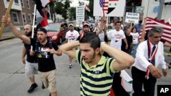 Members of the local Syrian community march in protest against the United States' involvement in Syria, Aug. 30, 2013, in Allentown, Pennsylvania. 