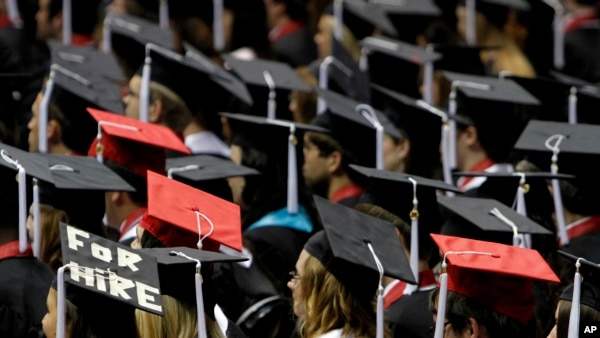 Students attend graduation ceremonies at the University of Alabama in Tuscaloosa, Ala. The number of borrowers defaulting on federal student loans has jumped sharply, the latest indication that rising college tuition costs, low graduation rates and poor job prospects are getting more and more students over their heads in debt. (AP) 