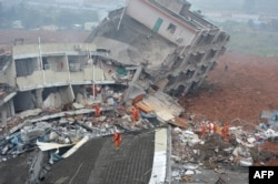Rescuers look for survivors after a landslide hit an industrial park in Shenzhen, south China's Guangdong province on Dec. 20, 2015.