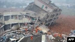 Rescuers look for survivors after a landslide hit an industrial park in Shenzhen, south China's Guangdong province on December 20, 2015.