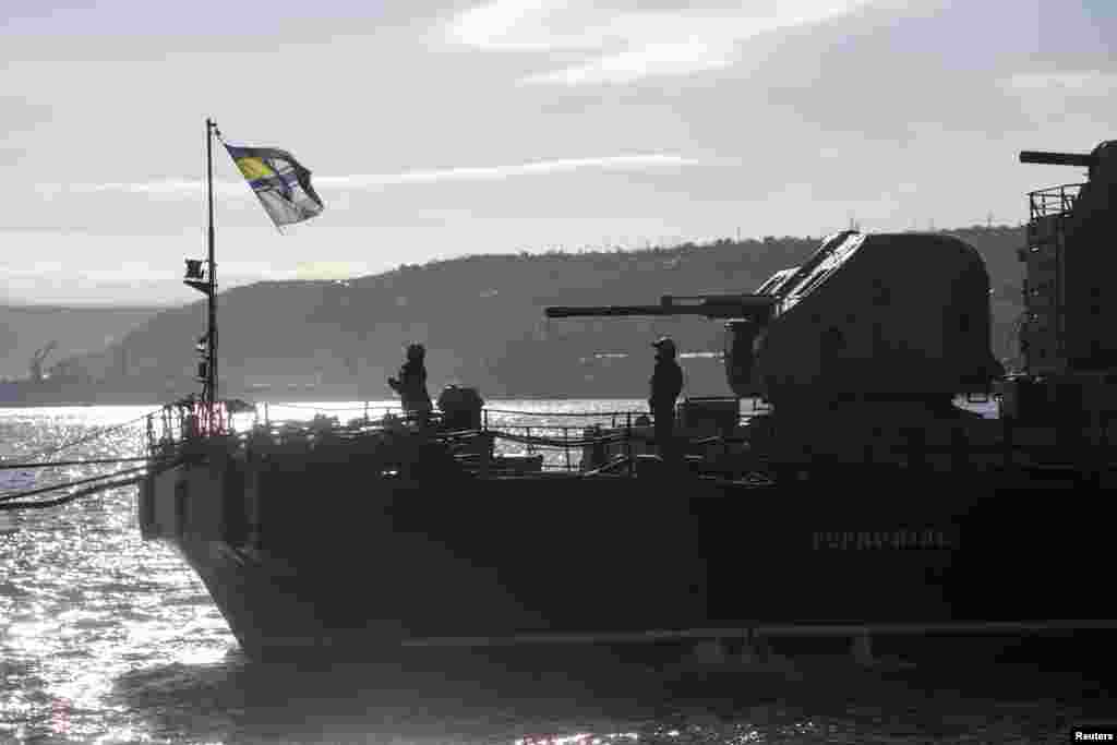 Ukrainian Navy solders raise their flag on top of the Ukrainian navy corvette Ternopil at the Crimean port of Sevastopol, March 5, 2014.