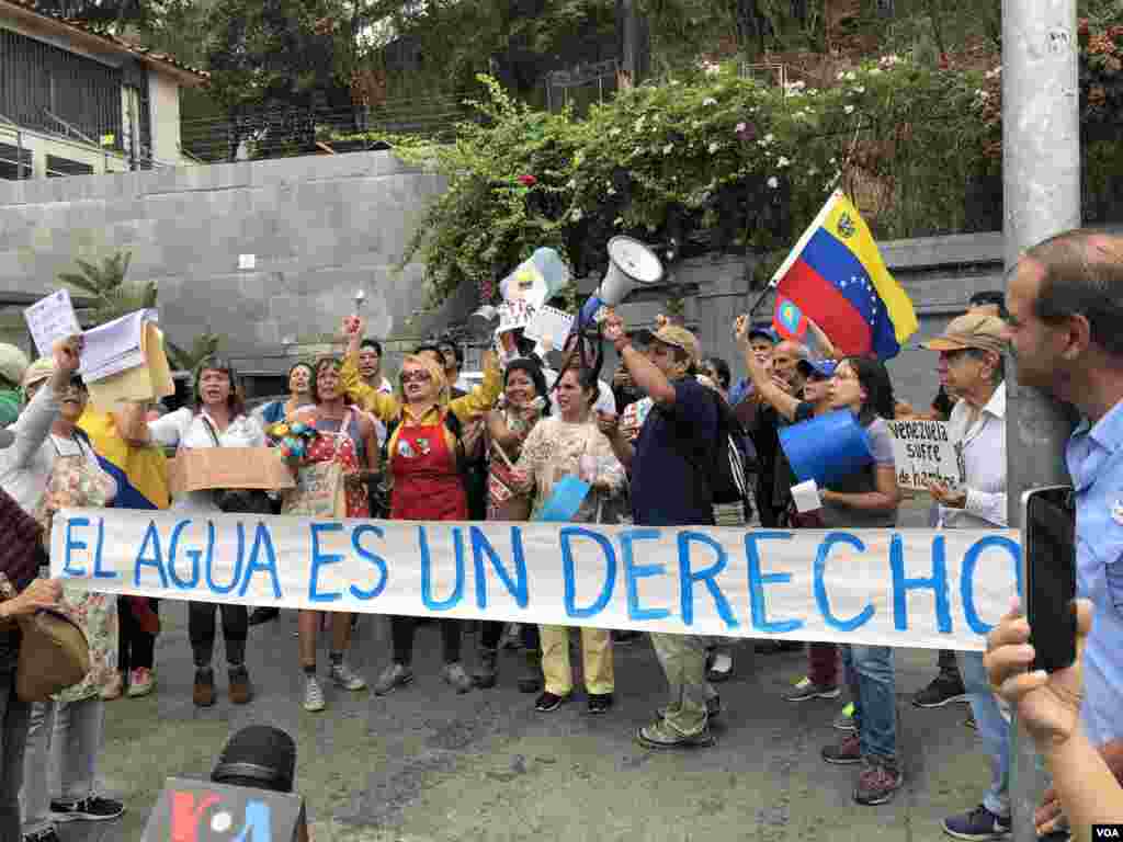 Manifestantes sostienen una pancarta que dice &quot;el agua es un derecho&quot;, durante una portesta por la escasez de agua en Venezuela.&nbsp;